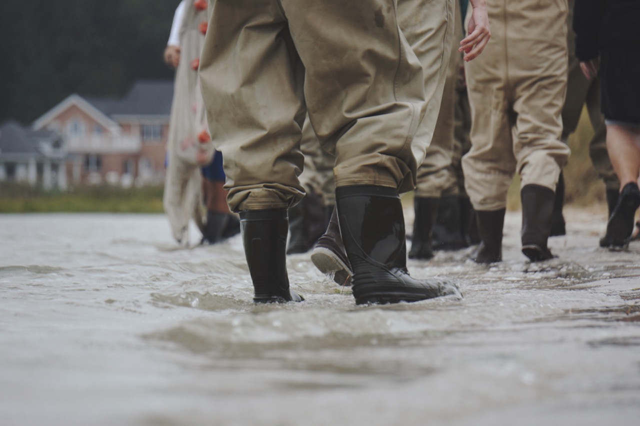Rain boots in muddy water, photo by The Tampa Bay Estuary from Unsplash